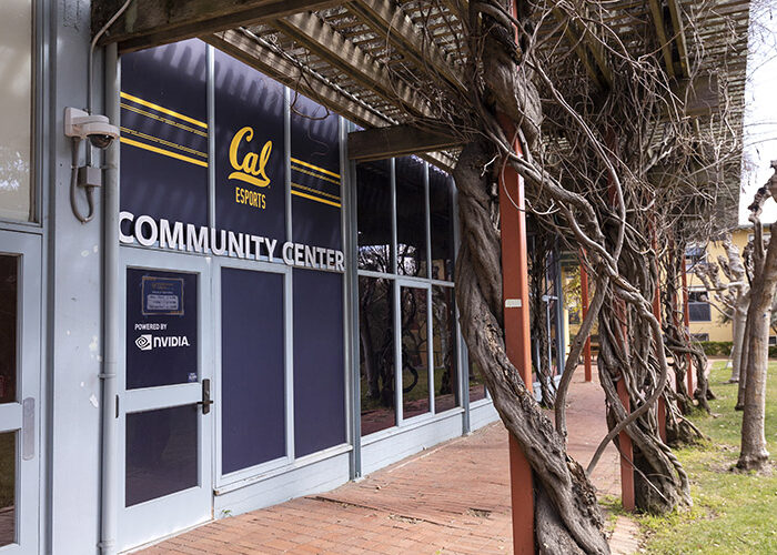 A cobblestone pathway is shown alongside the Cal Esports Community Center.